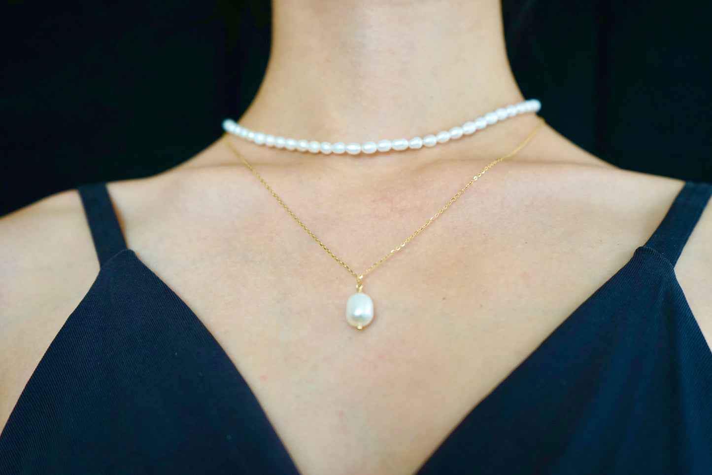 A pearl pendant necklace made of 14K gold-plated sterling silver, paired with a rice pearl strand necklace