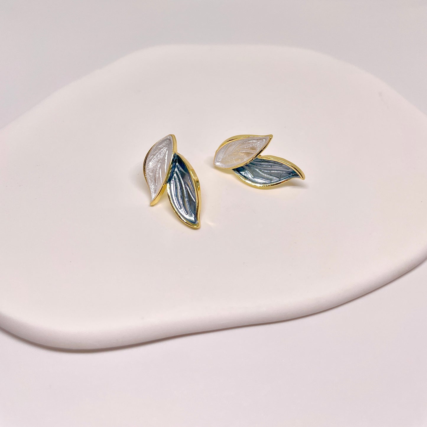 Blue and white leaf-shaped earrings